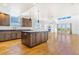 Bright and airy living space with hardwood floors connecting the kitchen at 497 Valley Way, Bennett, CO 80102
