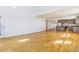 Open-concept living space featuring hardwood floors, abundant natural light, and modern kitchen at 497 Valley Way, Bennett, CO 80102
