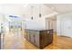 Open-concept design with great natural light, hardwood floors and spacious kitchen island at 497 Valley Way, Bennett, CO 80102