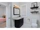 Charming bathroom with black vanity, marble countertop, and modern fixtures at 2424 N Clay St, Denver, CO 80211