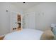 Bedroom with an open door to the kitchen has a closet and white walls at 2424 N Clay St, Denver, CO 80211