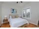 Bright bedroom features hardwood floors, a double-paned window, and neutral decor at 2424 N Clay St, Denver, CO 80211