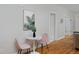 Charming dining area with a round table, pink chairs, and a leafy painting at 2424 N Clay St, Denver, CO 80211