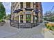 Charming building exterior featuring brickwork, balcony, and outdoor dining area with rustic wood accents at 2424 N Clay St, Denver, CO 80211