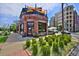 Briar Common Brewery with outdoor dining featuring a brick facade and a rooftop patio with awning at 2424 N Clay St, Denver, CO 80211