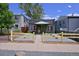 Street view of charming green single-story house with decorative stars and a small front yard with yellow fence at 2424 N Clay St, Denver, CO 80211