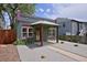 Charming single-story home featuring an inviting porch, decorative stars, and low-maintenance gravel landscaping at 2424 N Clay St, Denver, CO 80211