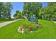 Well-manicured lawn and garden at Jefferson Park with walking paths and green trees at 2424 N Clay St, Denver, CO 80211