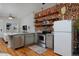 Open kitchen with stainless steel appliances, gray cabinets, and breakfast bar with seating at 2424 N Clay St, Denver, CO 80211