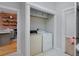 Laundry closet featuring washer and dryer with access to kitchen and bedroom at 2424 N Clay St, Denver, CO 80211