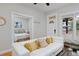 Cozy living room with a white sofa and view of the bedroom through doorway at 2424 N Clay St, Denver, CO 80211