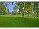 Lush park with mature trees and green grass, offering a serene and inviting outdoor space at 2424 N Clay St, Denver, CO 80211