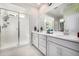 Light-filled bathroom with double vanity, glass shower, and contemporary fixtures at 23652 E 40Th Ave, Aurora, CO 80019