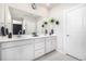 Bright bathroom featuring a double vanity, large mirror, and modern fixtures at 23652 E 40Th Ave, Aurora, CO 80019