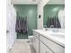 A charming bathroom with double sinks, white cabinets, and a unique sea-themed decor at 23652 E 40Th Ave, Aurora, CO 80019