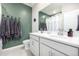 A well-lit bathroom with double sinks and charming green accent wall at 23652 E 40Th Ave, Aurora, CO 80019