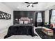 Stylish bedroom with a dark accent wall, plush bedding, and modern decor at 23652 E 40Th Ave, Aurora, CO 80019