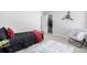 A cozy bedroom featuring a simple bed frame and open closet space at 23652 E 40Th Ave, Aurora, CO 80019
