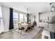 Elegant dining area with large windows, stylish lighting, and comfortable seating at 23652 E 40Th Ave, Aurora, CO 80019