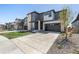 Charming two-story home with a well-maintained lawn, mature landscaping, and a spacious two car garage at 23652 E 40Th Ave, Aurora, CO 80019