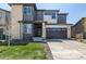 Attractive two-story home featuring stone and siding details, a paved driveway and well kept lawn at 23652 E 40Th Ave, Aurora, CO 80019
