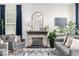Cozy living room featuring a stone fireplace, hardwood floors, and neutral furniture, bathed in natural light at 23652 E 40Th Ave, Aurora, CO 80019