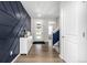 Welcoming foyer with stylish navy accent wall, light wood floors, and a view of the staircase at 23652 E 40Th Ave, Aurora, CO 80019