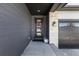 Inviting entryway with stone accents, dark wood siding, and a modern glass front door with a festive wreath at 23652 E 40Th Ave, Aurora, CO 80019