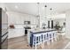 Kitchen features a large island, stainless steel appliances, and views of the living area at 23652 E 40Th Ave, Aurora, CO 80019