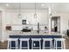 Kitchen features an island with seating, stainless steel appliances, and ample cabinet space at 23652 E 40Th Ave, Aurora, CO 80019