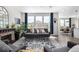 Comfortable living room with a gray sofa, fireplace, and an open view into the dining area at 23652 E 40Th Ave, Aurora, CO 80019