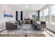 Bright living room with a decorative fireplace, stylish gray sofas, and large windows with modern blue curtains at 23652 E 40Th Ave, Aurora, CO 80019