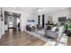 Bright living room featuring a fireplace, modern furniture, and hardwood floors at 23652 E 40Th Ave, Aurora, CO 80019