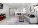 Inviting living room with a comfortable gray sofa, a coffee table on a rug, and nice wall art at 23652 E 40Th Ave, Aurora, CO 80019