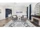 Living room featuring hardwood floors, fireplace and blue accent wall, and lots of natural light at 23652 E 40Th Ave, Aurora, CO 80019