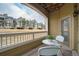 Outdoor balcony features seating and views of grass and nearby buildings for outdoor relaxing at 6021 W Castlegate Dr # E18, Castle Rock, CO 80108