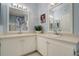 Bright bathroom featuring double sinks and well-placed mirrors, creating a functional and comfortable space at 6021 W Castlegate Dr # E18, Castle Rock, CO 80108