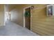 Apartment entrance featuring a brown door with a green wreath and numbered E18 at 6021 W Castlegate Dr # E18, Castle Rock, CO 80108
