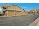 Condo garages and parking area with a view of the surrounding complex and neighborhood at 6021 W Castlegate Dr # E18, Castle Rock, CO 80108