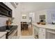 Open kitchen with stainless steel appliances connecting to a dining area, offering an inviting and modern living space at 6021 W Castlegate Dr # E18, Castle Rock, CO 80108