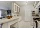 Bright kitchen featuring white cabinets, tiled backsplash, and modern appliances, offering a clean and functional space at 6021 W Castlegate Dr # E18, Castle Rock, CO 80108