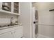 Convenient laundry room with a stacked washer and dryer, and storage, providing efficiency at 6021 W Castlegate Dr # E18, Castle Rock, CO 80108