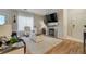 Bright living room featuring hardwood floors, fireplace, and a modern rug at 6021 W Castlegate Dr # E18, Castle Rock, CO 80108