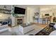 Bright living room featuring hardwood floors, fireplace, and a modern rug at 6021 W Castlegate Dr # E18, Castle Rock, CO 80108