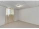 Carpeted basement corner with a window providing natural light showcases potential living space at 909 E 7Th Ave, Broomfield, CO 80020