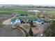 Extensive property with multiple structures, a pond, white fencing, and mature landscaping, set amidst vast open fields at 6231 Prospect Rd, Longmont, CO 80503