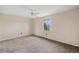 Neutral bedroom featuring a window, ceiling fan, and carpeting at 6231 Prospect Rd, Longmont, CO 80503