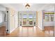 Welcoming entryway featuring hardwood floors, neutral paint, double doors leading to the backyard and a coat closet at 6231 Prospect Rd, Longmont, CO 80503