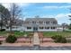 Charming two-story home featuring a well-manicured front lawn, complemented by a classic white picket fence and inviting walkway at 6231 Prospect Rd, Longmont, CO 80503