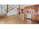 Bright kitchen featuring wood cabinets, a breakfast bar, and an adjoining living space at 6231 Prospect Rd, Longmont, CO 80503